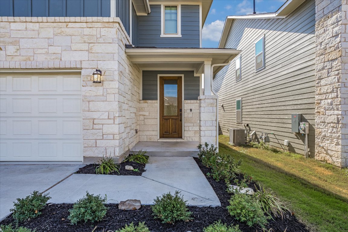 168 Kings Cyn Drive Dripping Springs, TX 78620 - Photo 3 of 25 a front view of a house with a yard