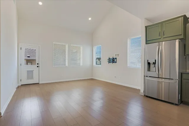 a view of a room with wooden floor