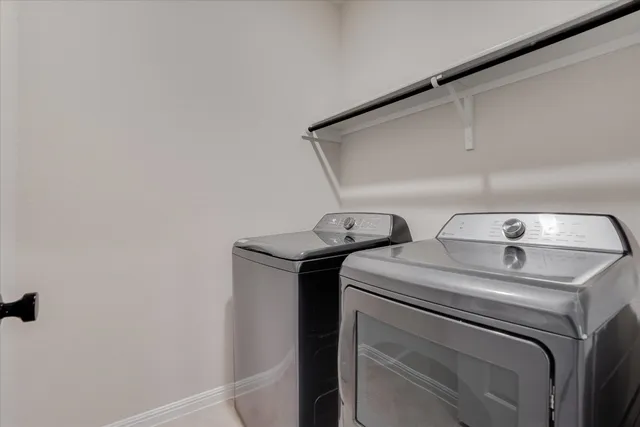 a view of a kitchen with wooden floors and refrigerator