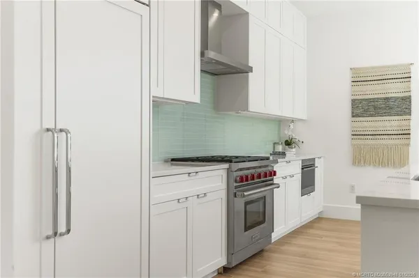 a kitchen with stainless steel appliances granite countertop a stove a sink and a refrigerator