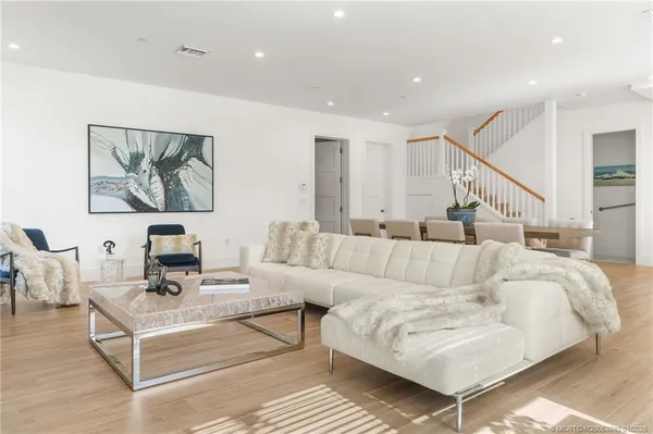 a living room with furniture a flat screen tv and a large window