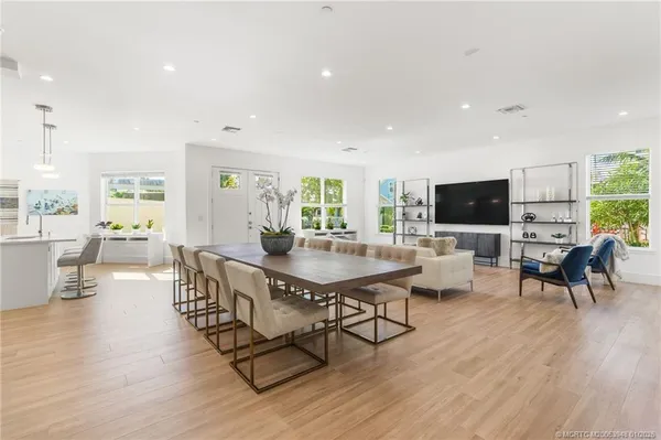 a living room with furniture tv and a large window