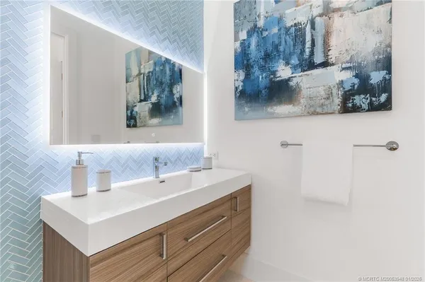 a bathroom with a double vanity sink mirror and toilet