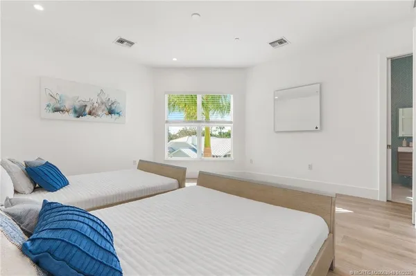 a bedroom with a large bed couch and a window