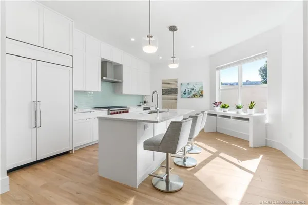 a kitchen that has a sink and a stove in it