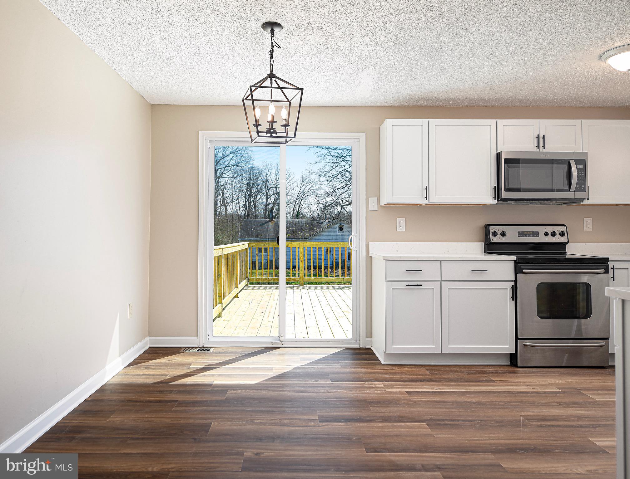 1811 Cape May Road Essex, MD 21221 - Photo 11 of 34 a view of a kitchen with wooden floor electronic appliances and windows