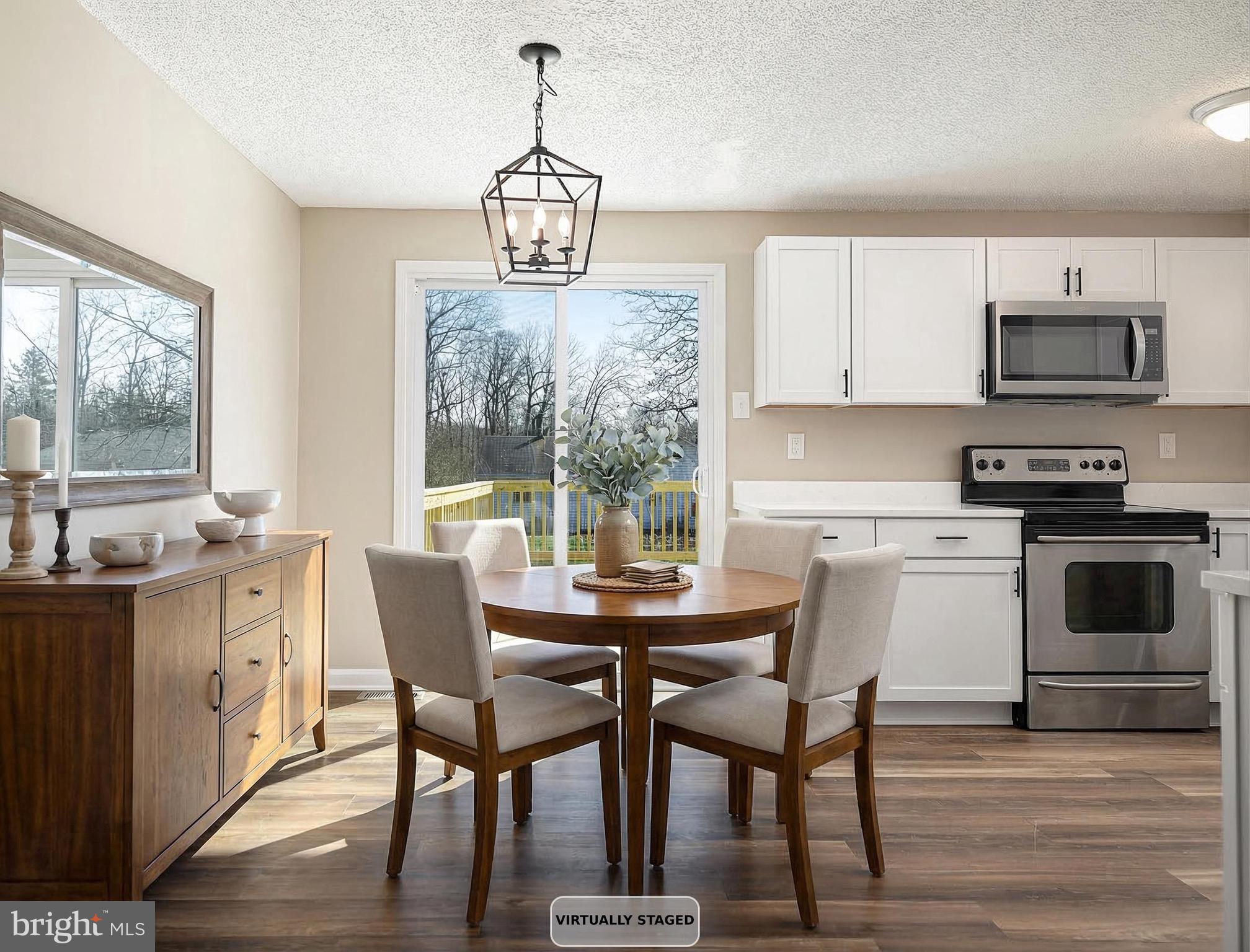 1811 Cape May Road Essex, MD 21221 - Photo 12 of 34 a view of a dining room with furniture a chandelier and wooden floor