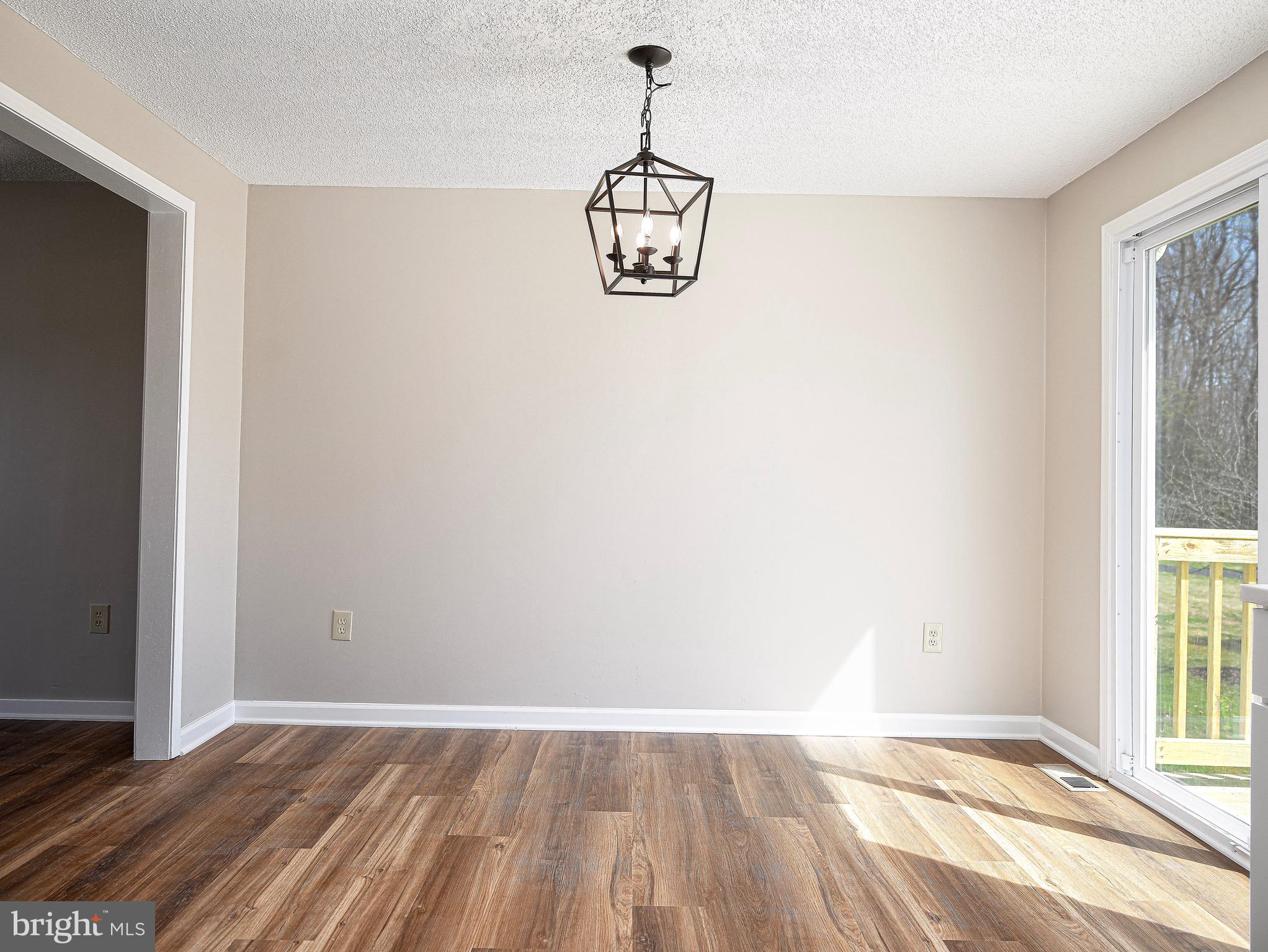 1811 Cape May Road Essex, MD 21221 - Photo 13 of 34 a view of a room with wooden floor exposed radiator and windows