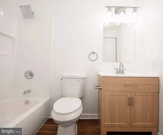 a bathroom with a sink a toilet and bathtub