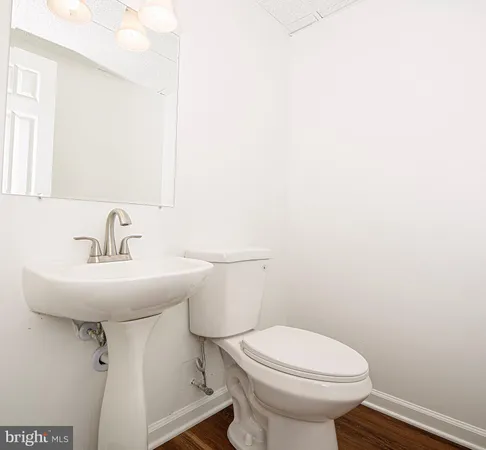 a bathroom with a sink a toilet and mirror