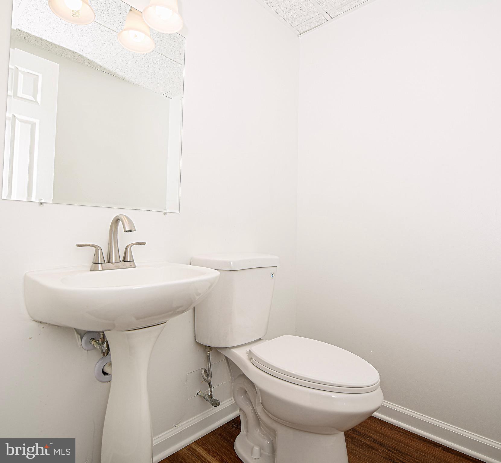 1811 Cape May Road Essex, MD 21221 - Photo 21 of 34 a bathroom with a sink a toilet and mirror