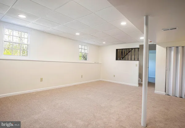 an empty room with windows and closet