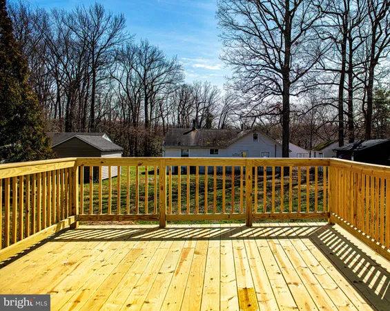 a view of a balcony with wooden floor and fence