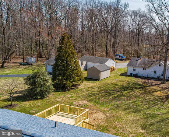 a view of a swimming pool with a patio and a yard
