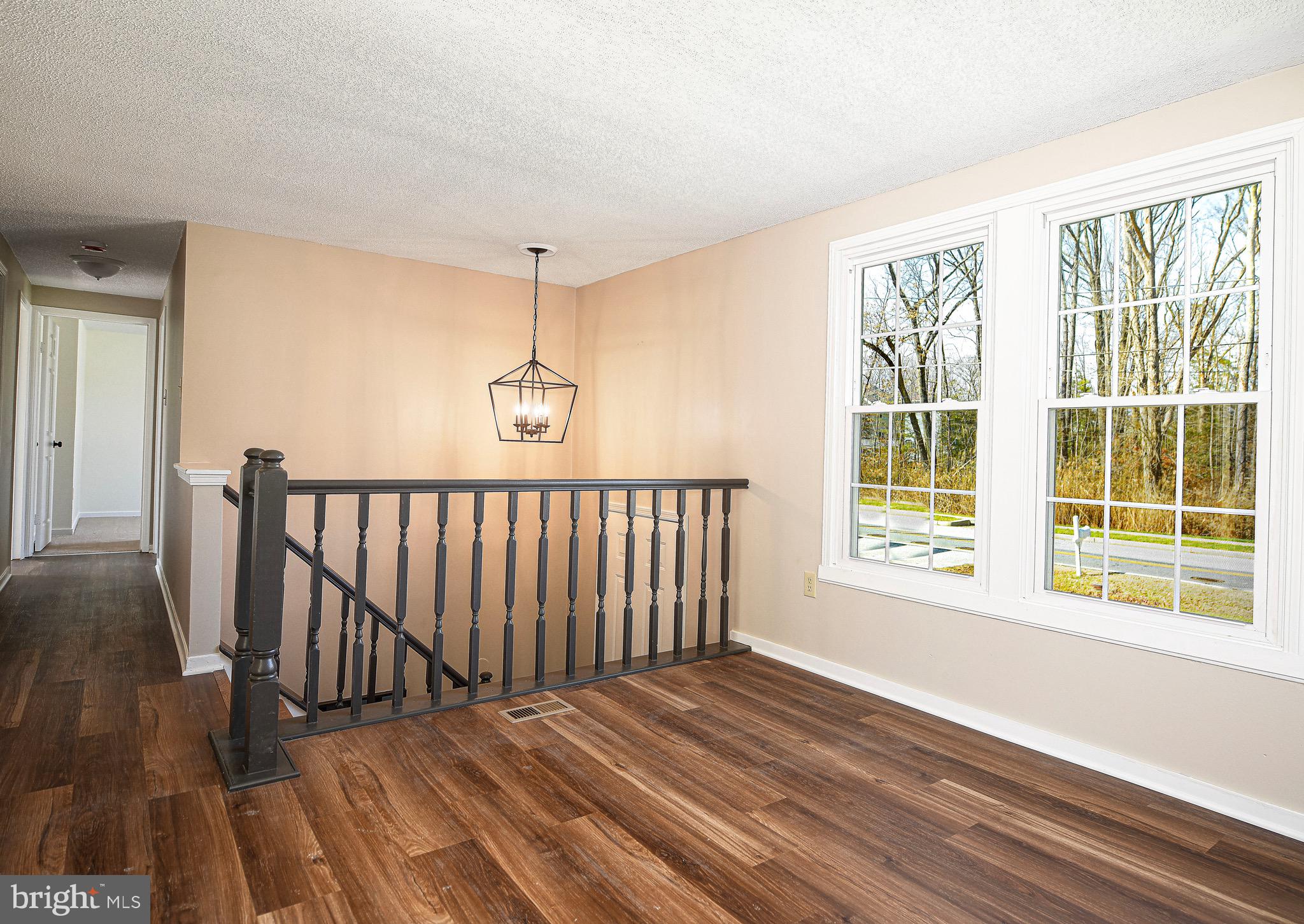 1811 Cape May Road Essex, MD 21221 - Photo 5 of 34 a view of an empty room with wooden floor and a window