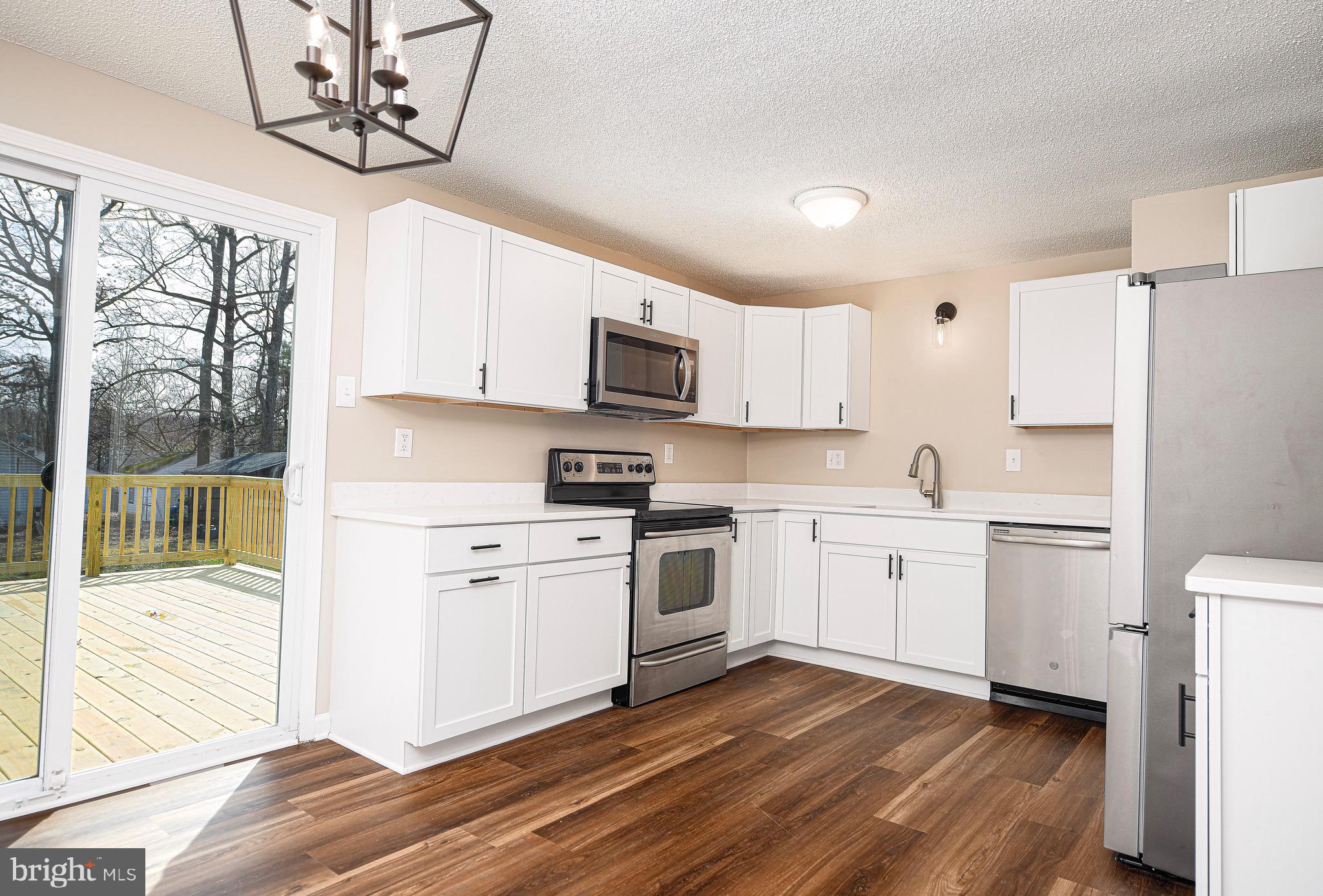 1811 Cape May Road Essex, MD 21221 - Photo 8 of 34 a kitchen with cabinets stainless steel appliances a sink and a window