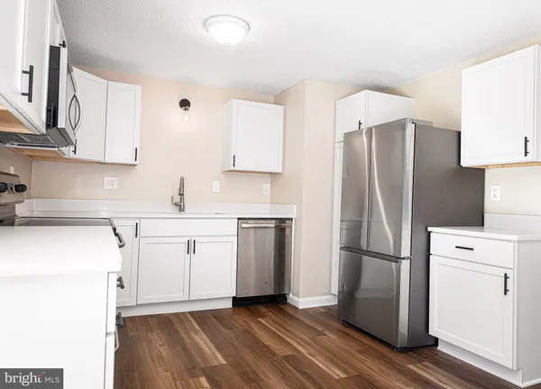 a kitchen with a refrigerator sink and microwave