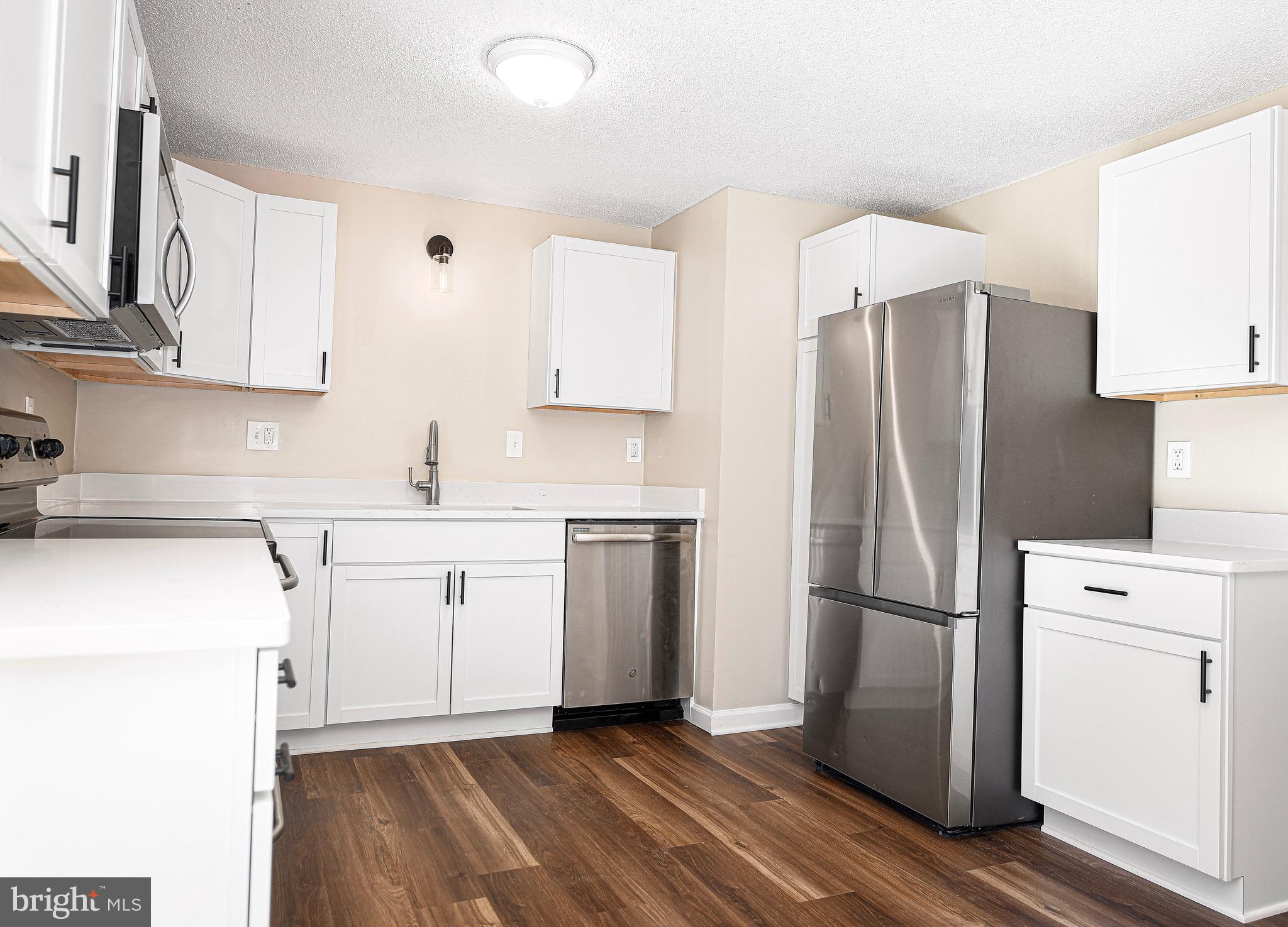 1811 Cape May Road Essex, MD 21221 - Photo 10 of 34 a kitchen with a refrigerator sink and microwave
