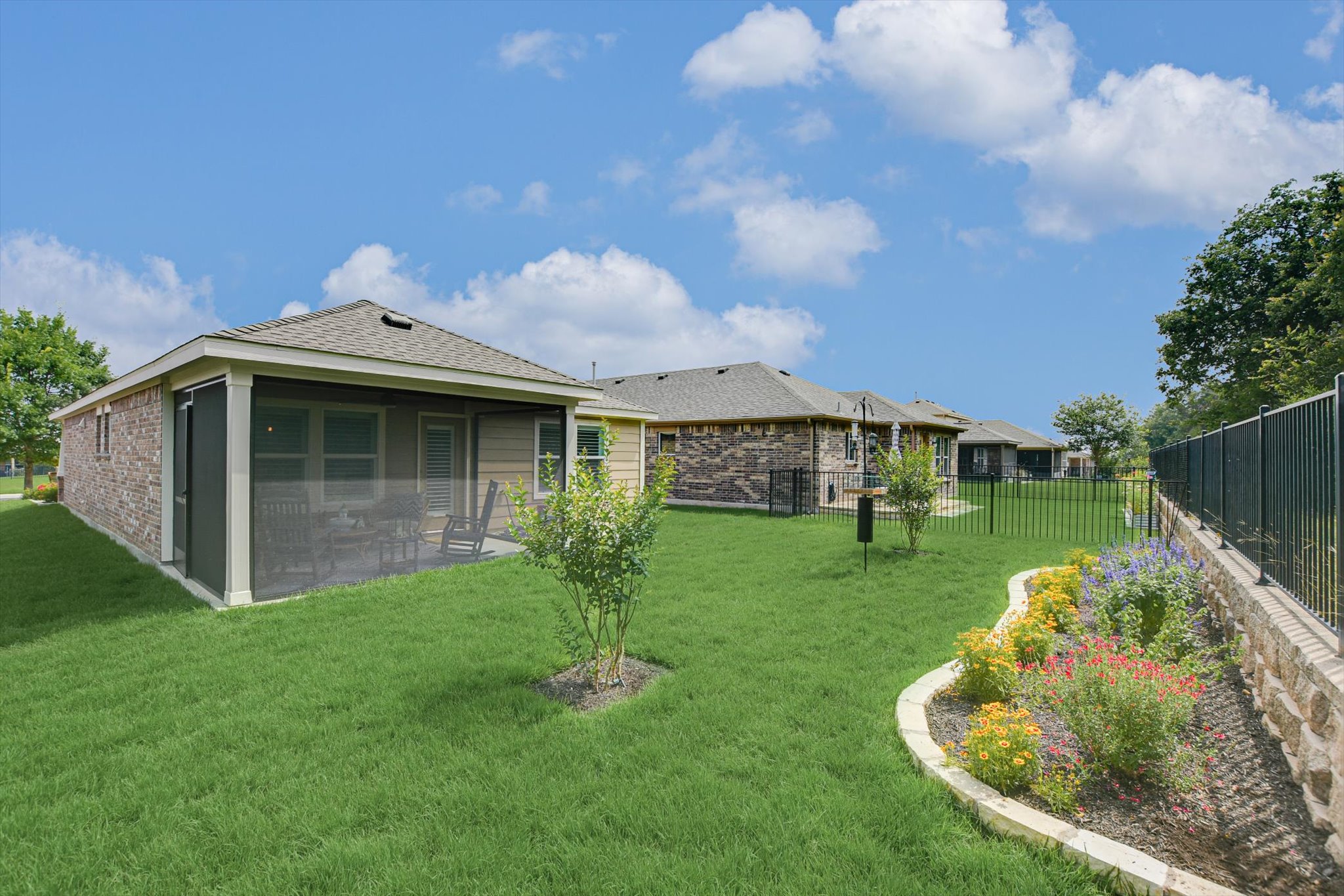 231 Hobby Street Georgetown, TX 78633 - Photo 25 of 29 A well-maintained lawn stretches towards a screened porch, ideal for outdoor relaxation.