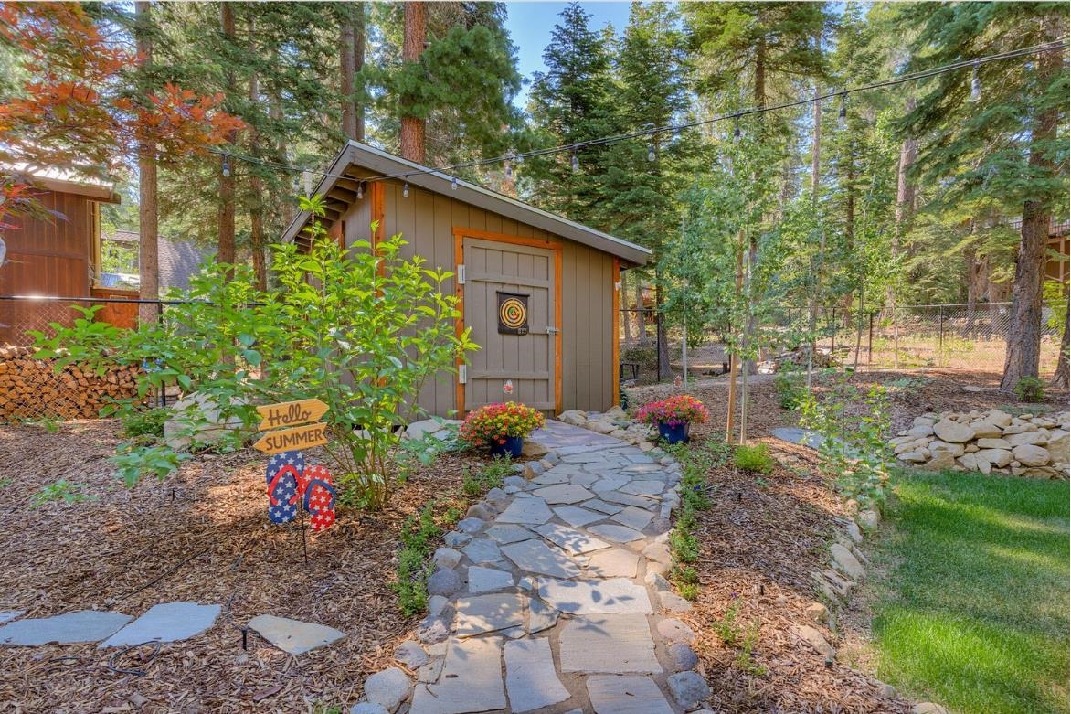 730 Cascade Circle Homewood, CA 96141 - Photo 12 of 22 a backyard of a house with wooden fence and plants