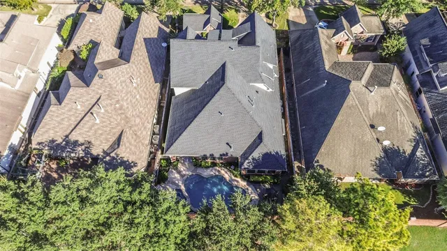 an aerial view of a house with a yard