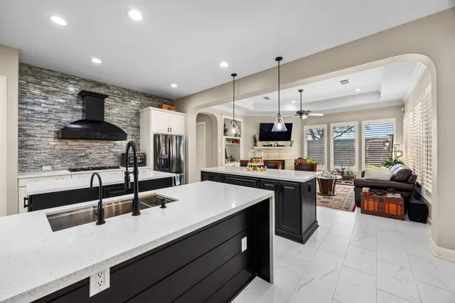 a kitchen with stainless steel appliances a sink stove and refrigerator