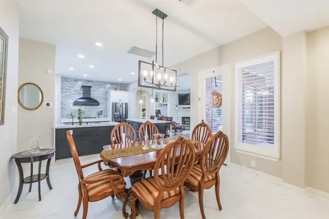a view of a dining room with furniture and chandelier