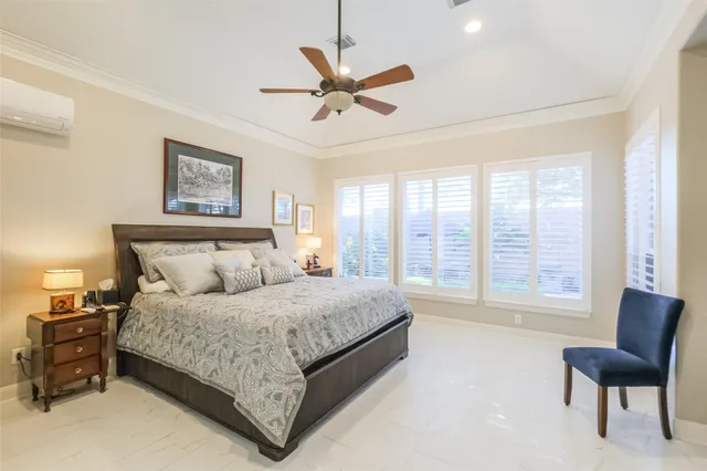 a bedroom with a bed dresser and window
