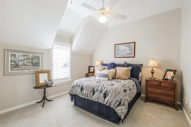 a spacious bedroom with a bed and a chandelier
