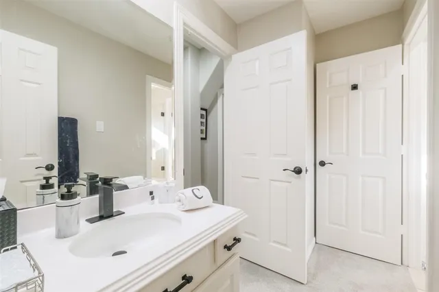 a bathroom with a sink a toilet and shower curtain