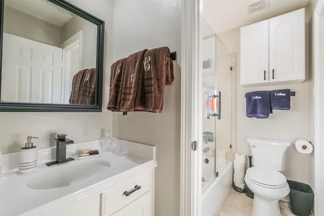 a kitchen with stainless steel appliances granite countertop a sink a stove and white cabinets