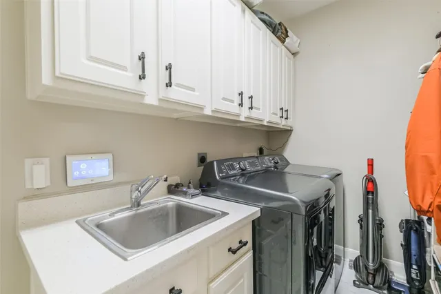 a kitchen with sink a stove and cabinets