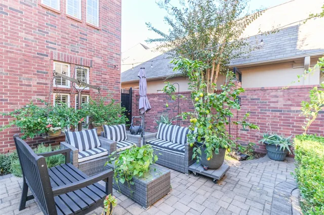 a view of a chair and table in back yard of a house
