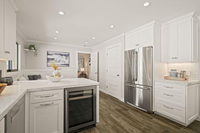a kitchen with a refrigerator sink and cabinets