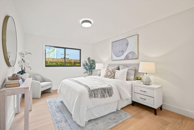 a bedroom with a bed and a large mirror