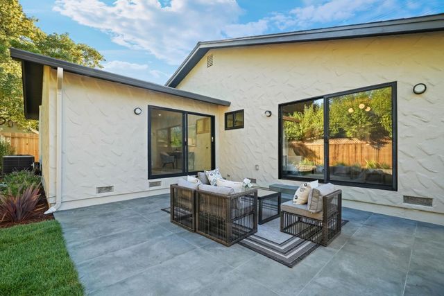 a building outdoor space with patio furniture and potted plants
