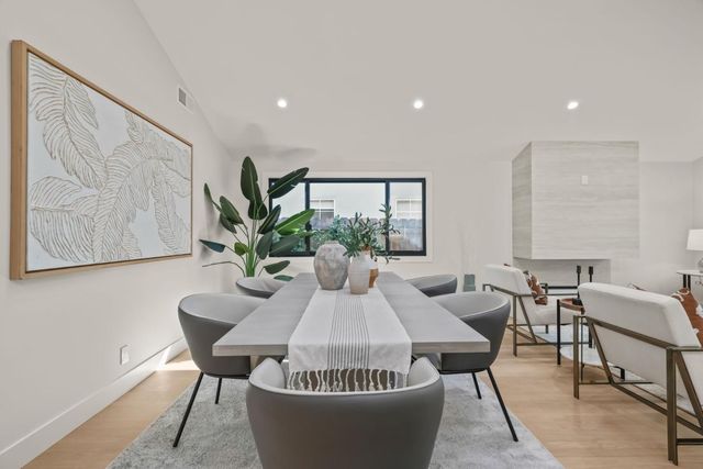 a dining room with furniture and wooden floor