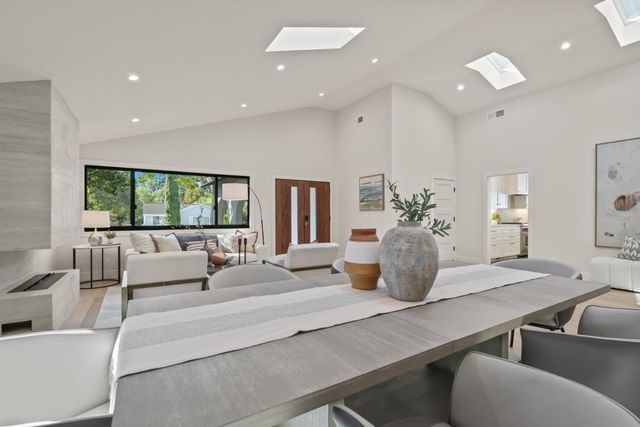 a living room with furniture potted plant and a large window