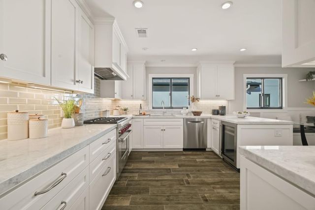 a kitchen with a sink stove and cabinets