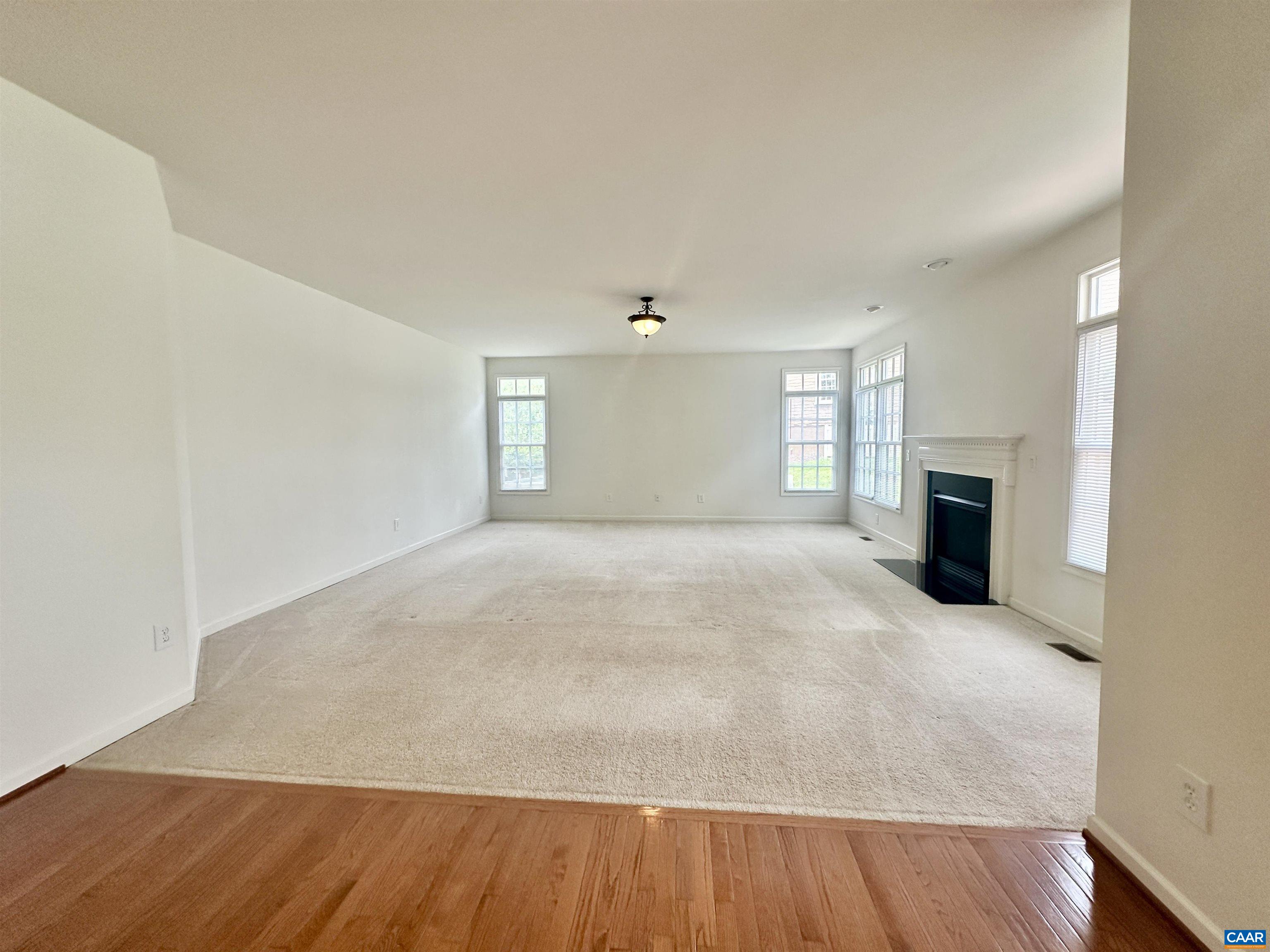 252 Millstream Drive Crozet, VA 22932 - Photo 5 of 41 a view of empty room with wooden floor and fireplace