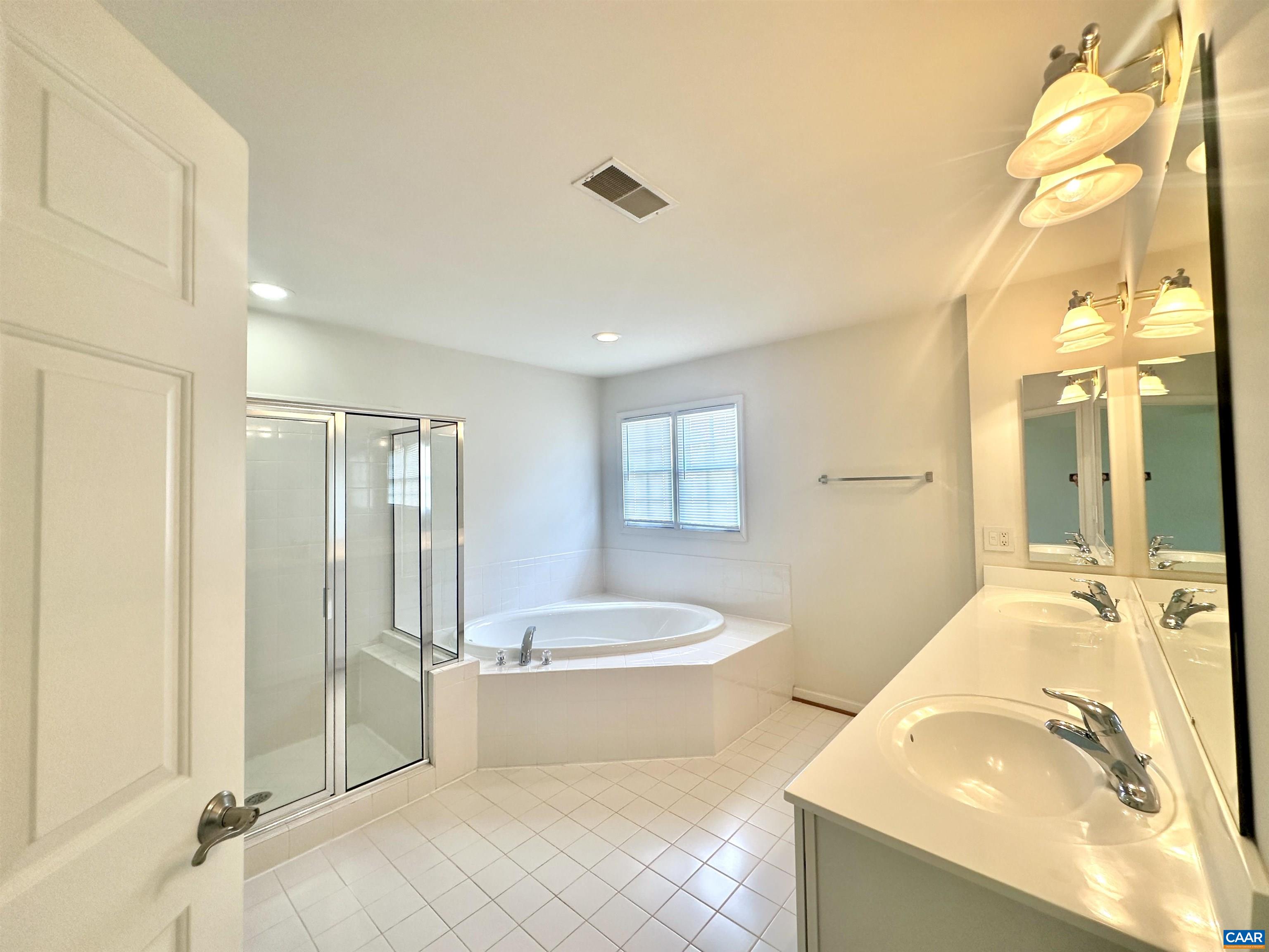 252 Millstream Drive Crozet, VA 22932 - Photo 7 of 41 a spacious bathroom with a tub sink and mirror