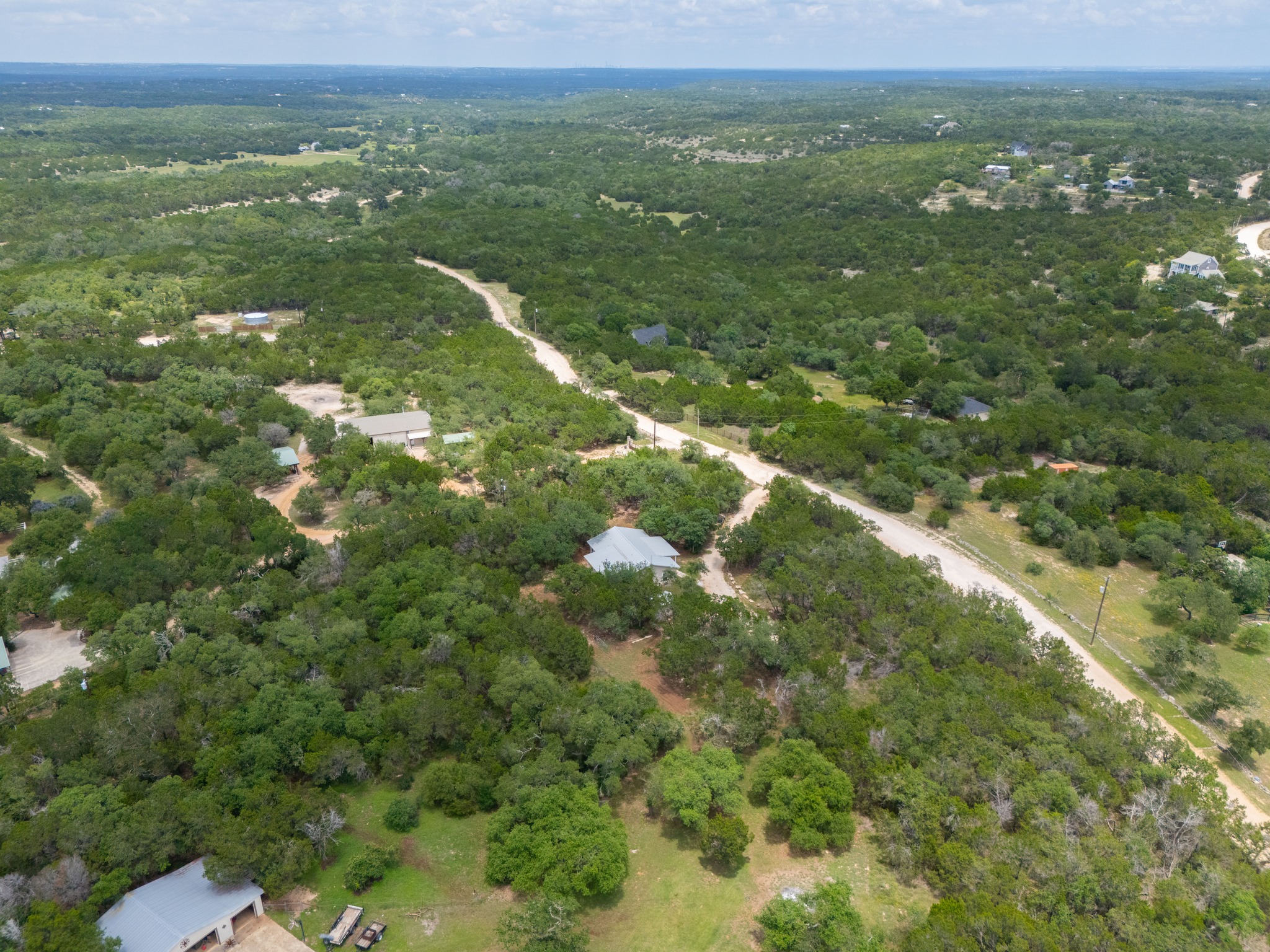 231 North Rainbow Ranch Road Wimberley, TX 78676 - Photo 37 of 40 Discover expansive acreage with natural foliage and winding roads, offering a secluded living opportunity.