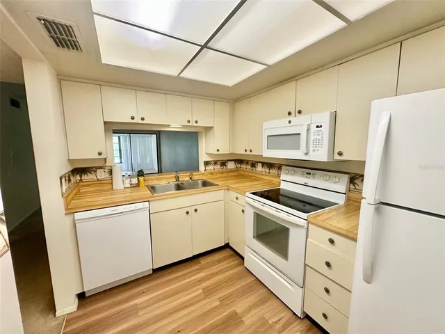 a kitchen with stainless steel appliances a refrigerator sink and cabinets