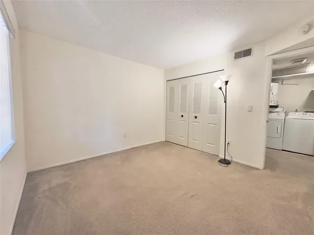 a view of a patio with a table and chairs and potted plants
