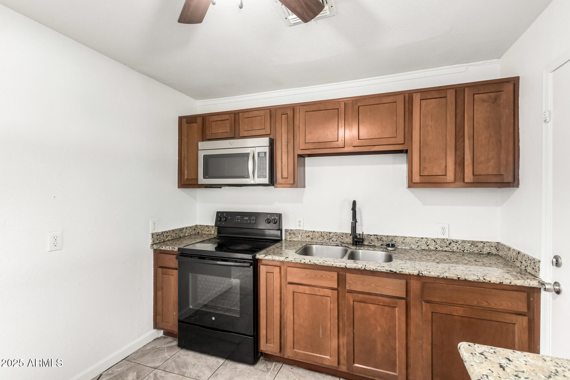 1010 East Chipman Road Phoenix, AZ 85040 - Photo 12 of 23 a kitchen with granite countertop a sink and a stove