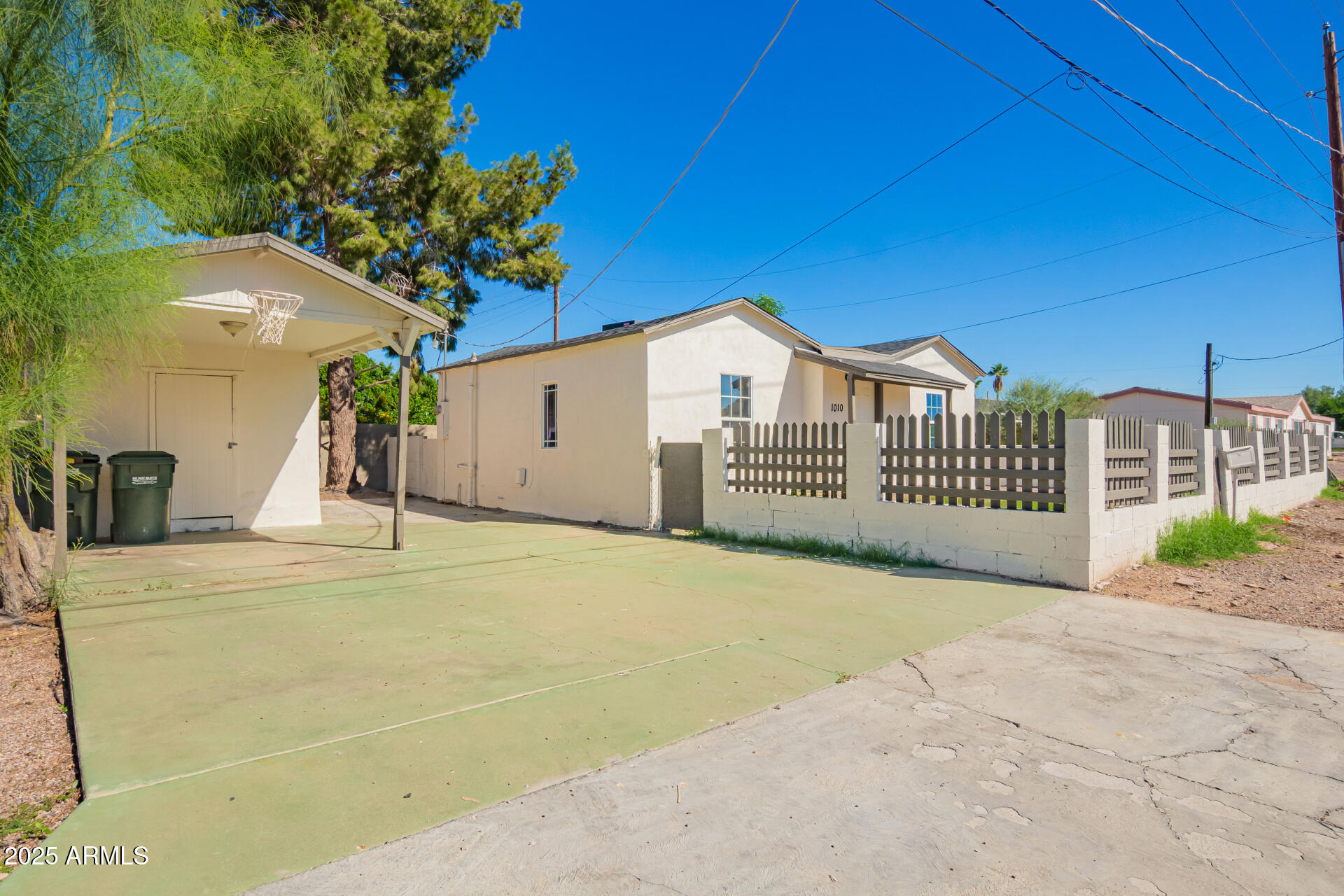 1010 East Chipman Road Phoenix, AZ 85040 - Photo 2 of 23 a view of a house with a yard and garage