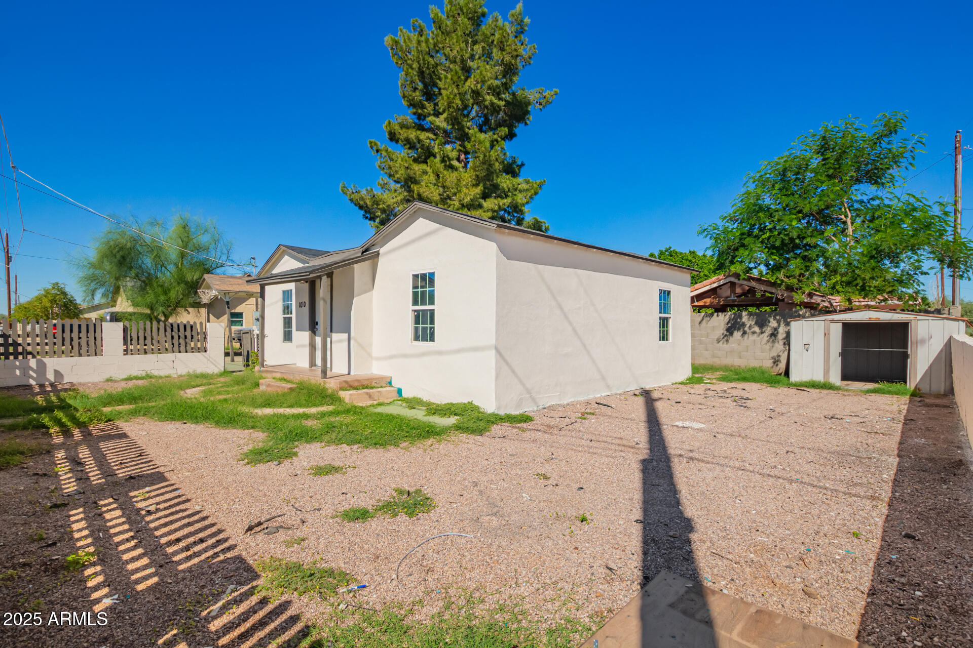 1010 East Chipman Road Phoenix, AZ 85040 - Photo 4 of 23 a white house with trees in front of it