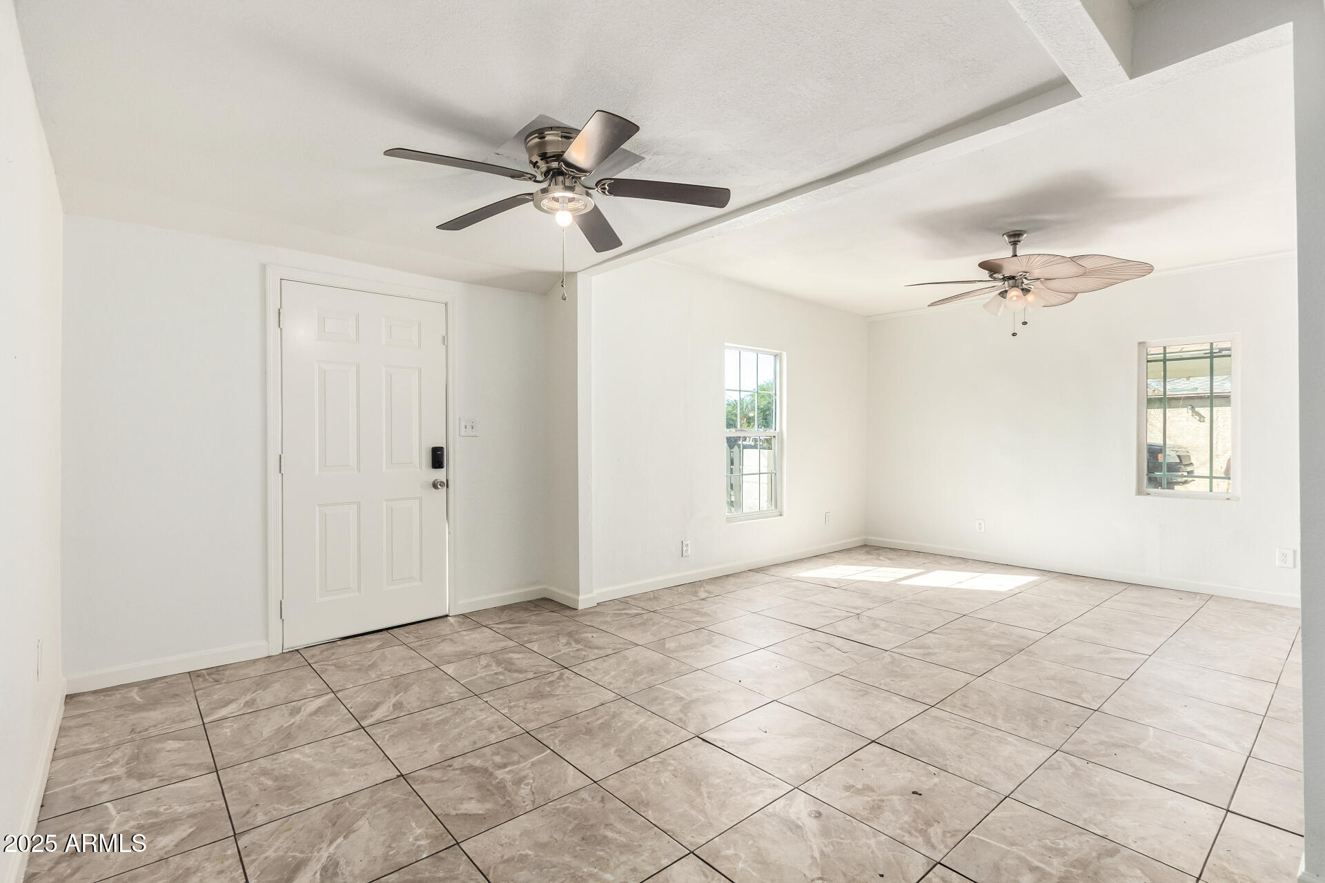 1010 East Chipman Road Phoenix, AZ 85040 - Photo 6 of 23 a view of a livingroom with a ceiling fan and window