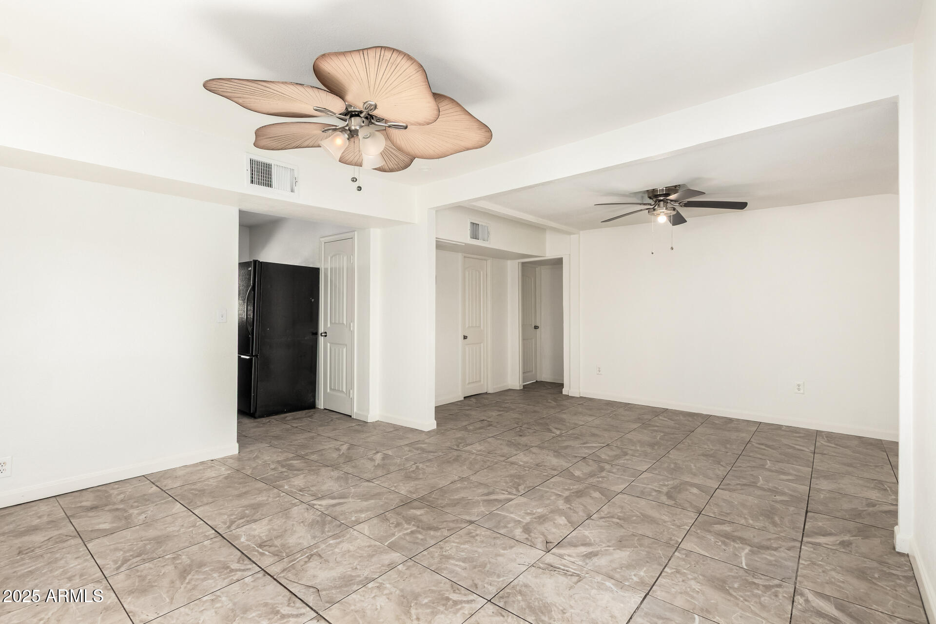 1010 East Chipman Road Phoenix, AZ 85040 - Photo 7 of 23 a view of an empty room and chandelier fan