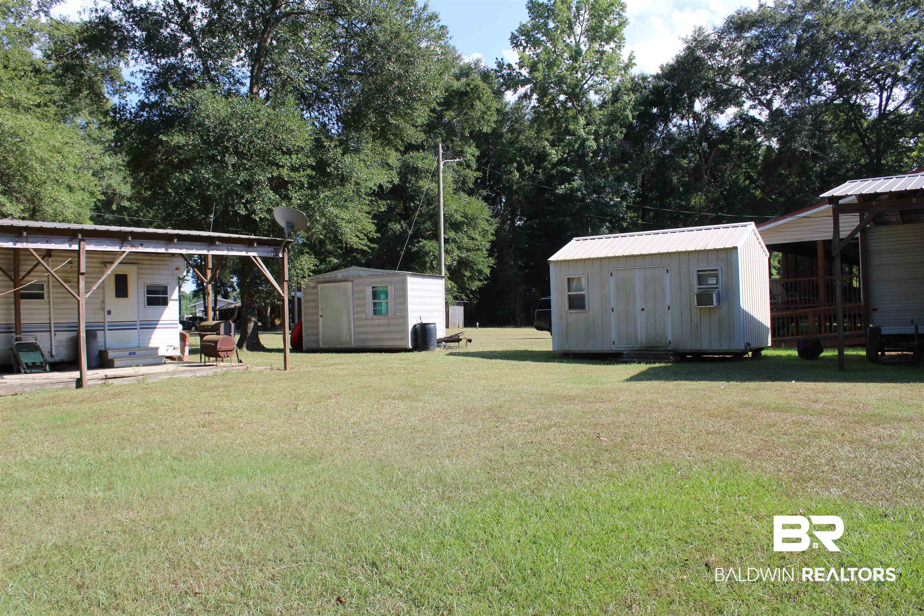 7258 Henderson Road Lowndesboro, AL 36752 - Photo 20 of 22 View of grassy yard featuring a storage unit and a detached carport